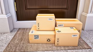 Four packages on the doormat outside the house, the door is closed.