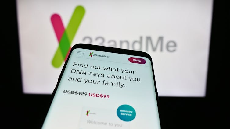 A smartphone with the website of the US biotechnology company 23andMe Inc. in front of the trademark.